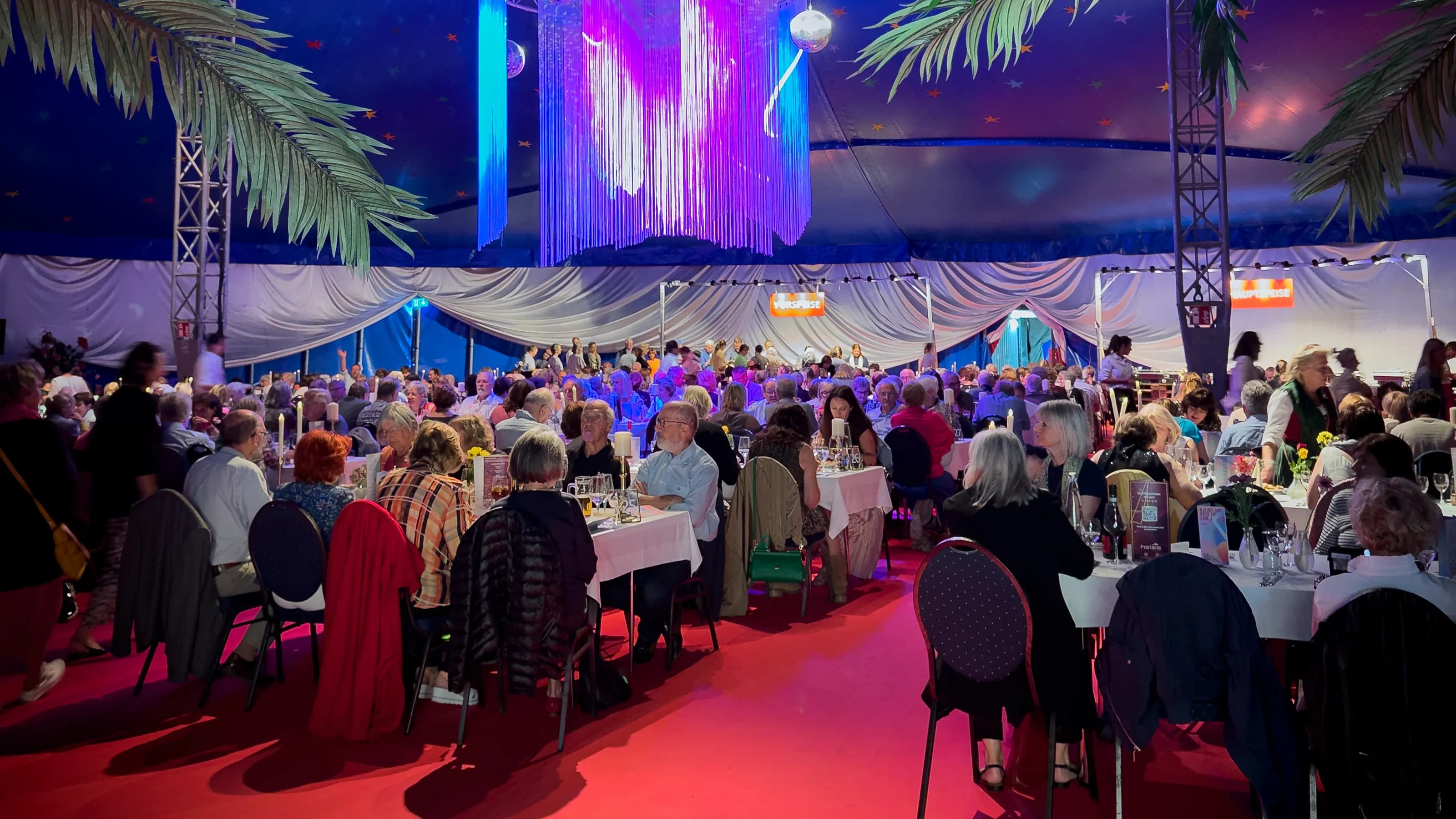 Veranstaltung mit gefüllten Esstischen